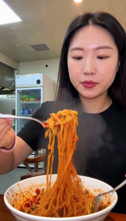 Preview of Spicy noodles twirled on a fork