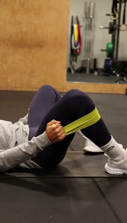 Preview of Resistance band clamshell exercise on a mat