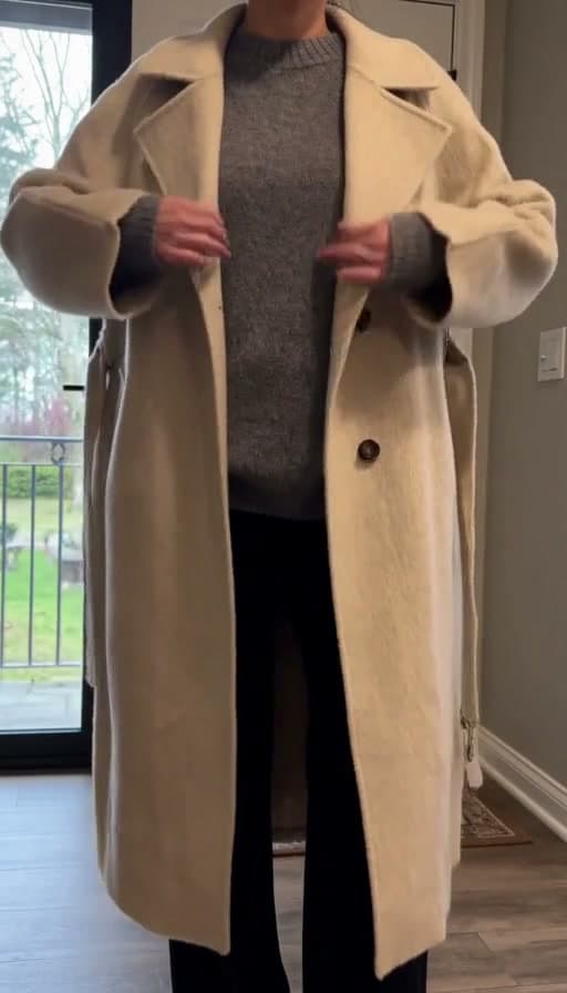 A frame from Wool coat buttoned closed at the entryway