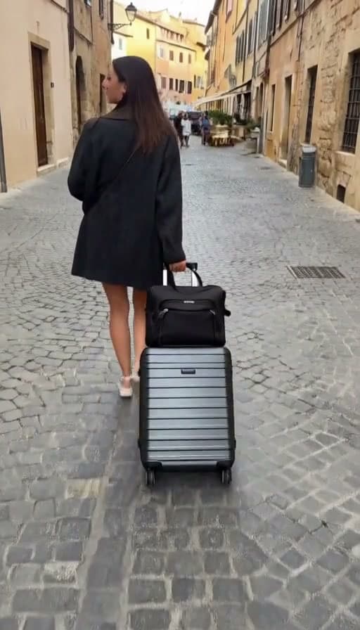 Preview of Suitcase wheeled down a cobblestone street