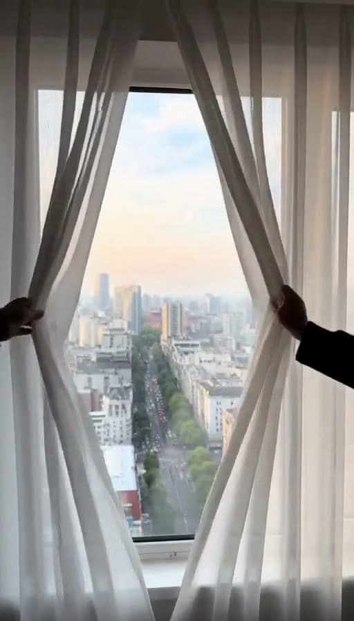 Preview of Hotel room curtains opened to reveal the view