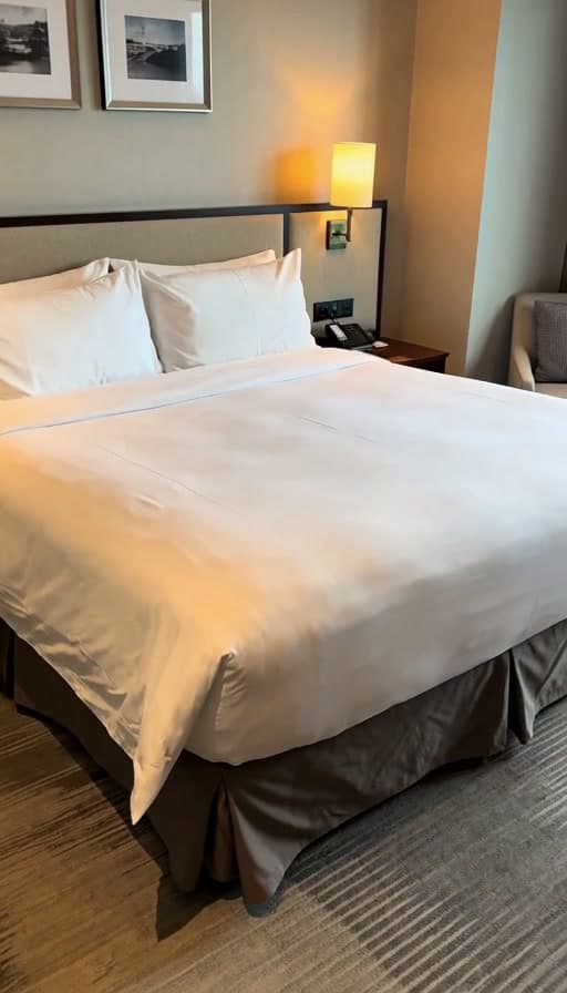 Preview of Hotel bed turned down, pillow fluffed